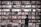 A middle-aged man with glasses, standing in front of a bookshelf filled with books.