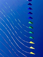 Close-up of vibrant kite strings tangled playfully in the wind