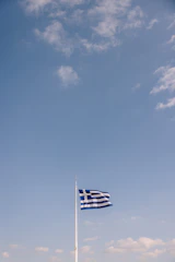 The flag of Acre state waving gently against a clear blue sky.