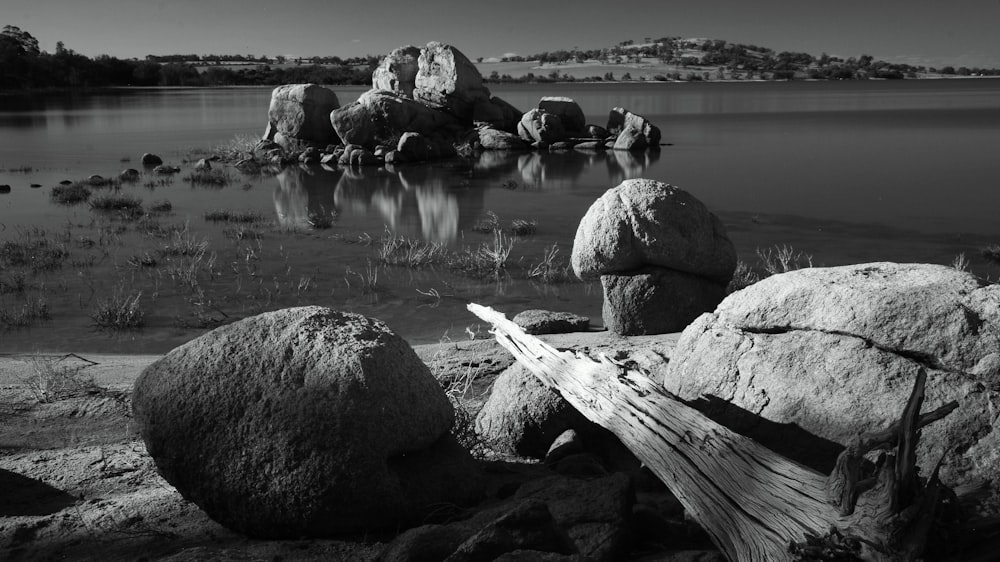 a black and white photo of rocks and water