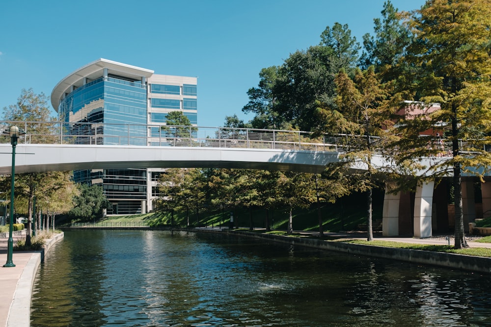 a bridge over a body of water with a building in the background