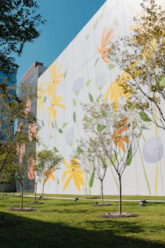 Outdoor cement wall with a colorful UV printed nature scene, vibrant under sunlight.