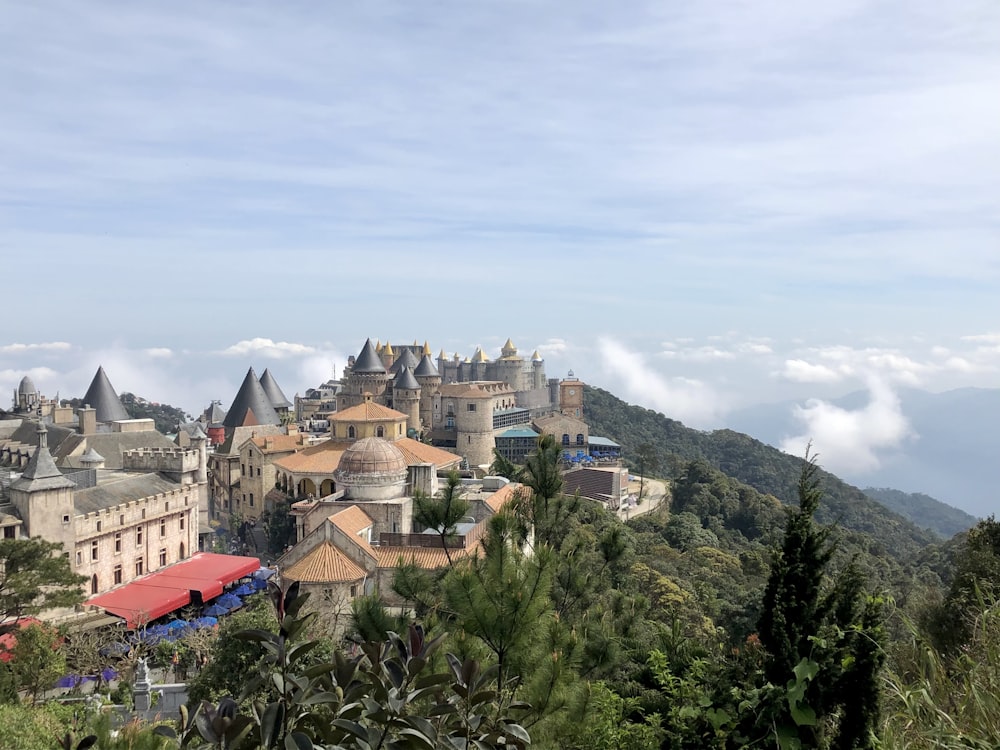 a castle on top of a mountain surrounded by trees