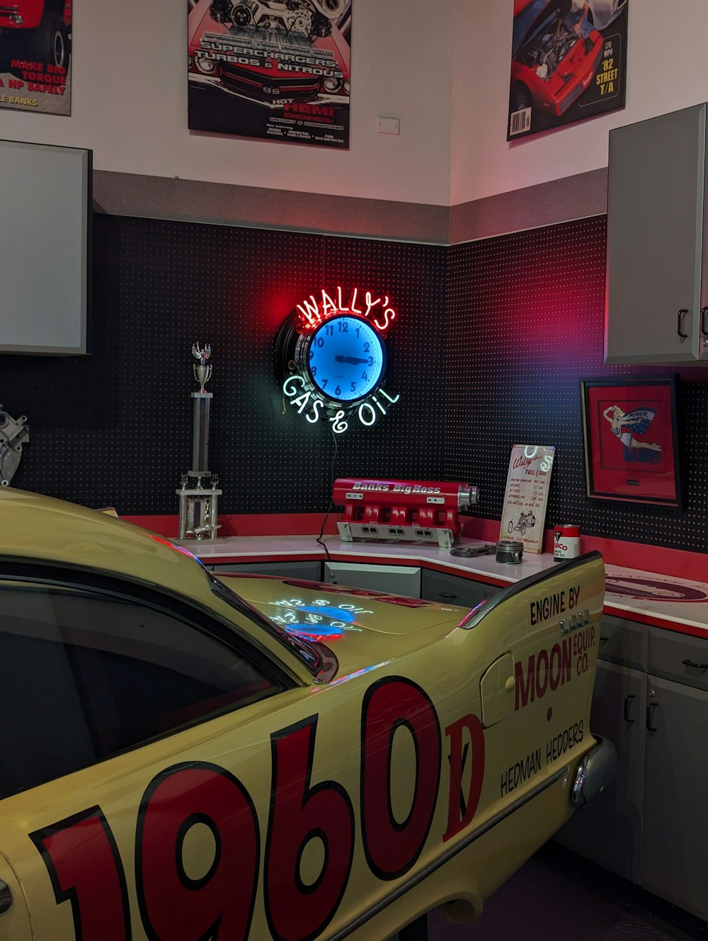 a yellow car parked in front of a neon sign