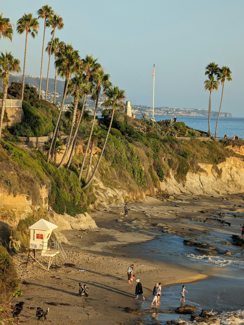 a group of people standing on top of a sandy beach