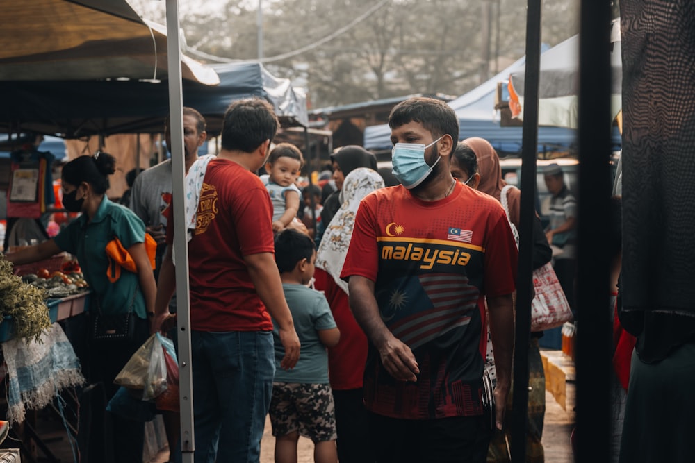 a group of people wearing face masks in a market