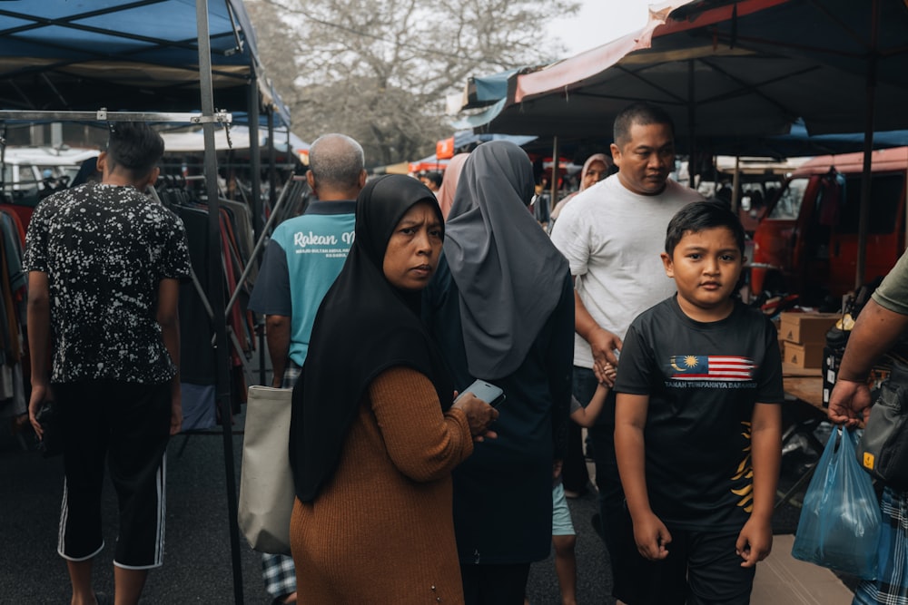 a group of people walking around a market