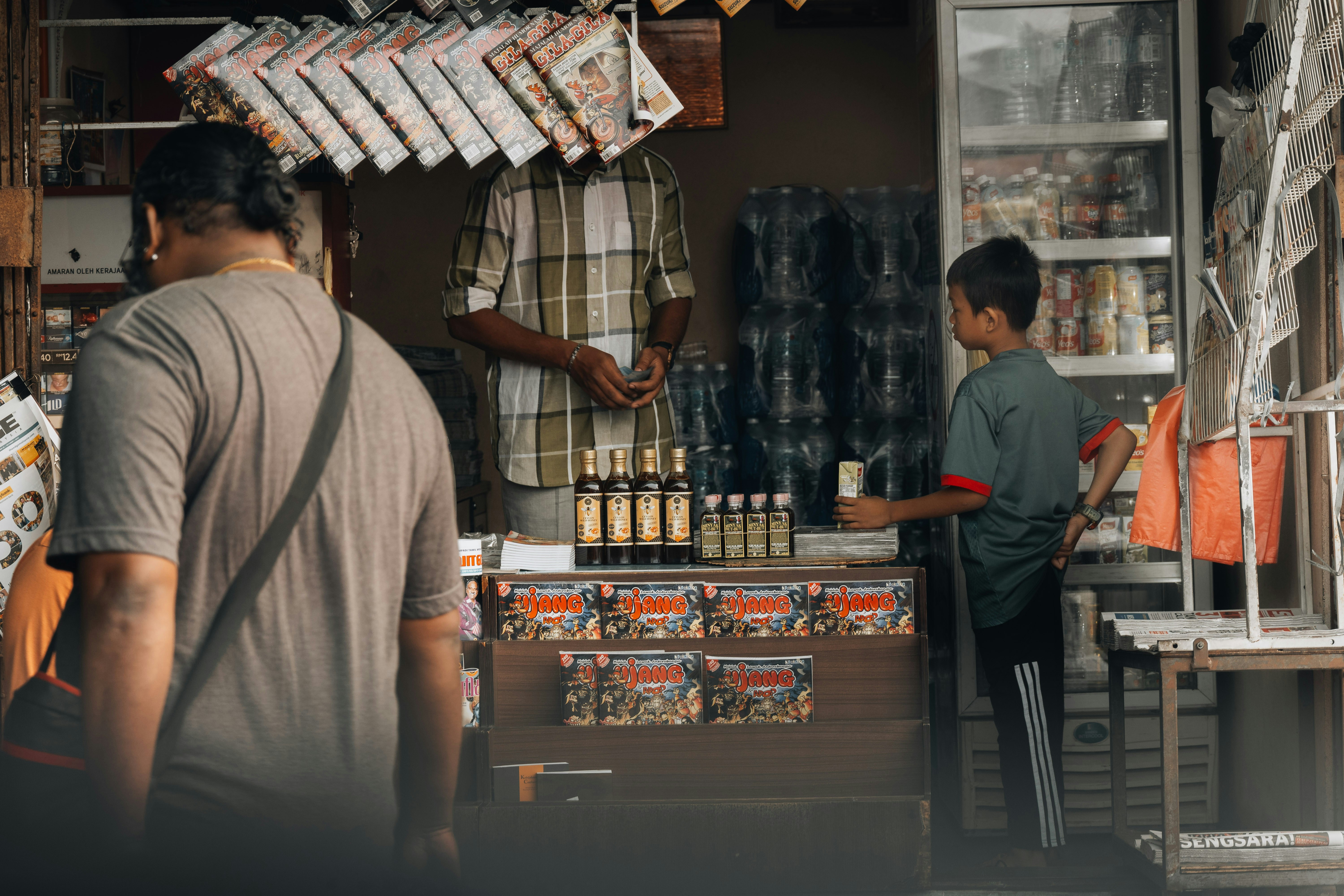 a man and a boy standing in front of a store