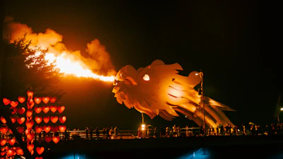 The fire-breathing dragon sculpture of Dragon Bridge lit up at night in Da Nang