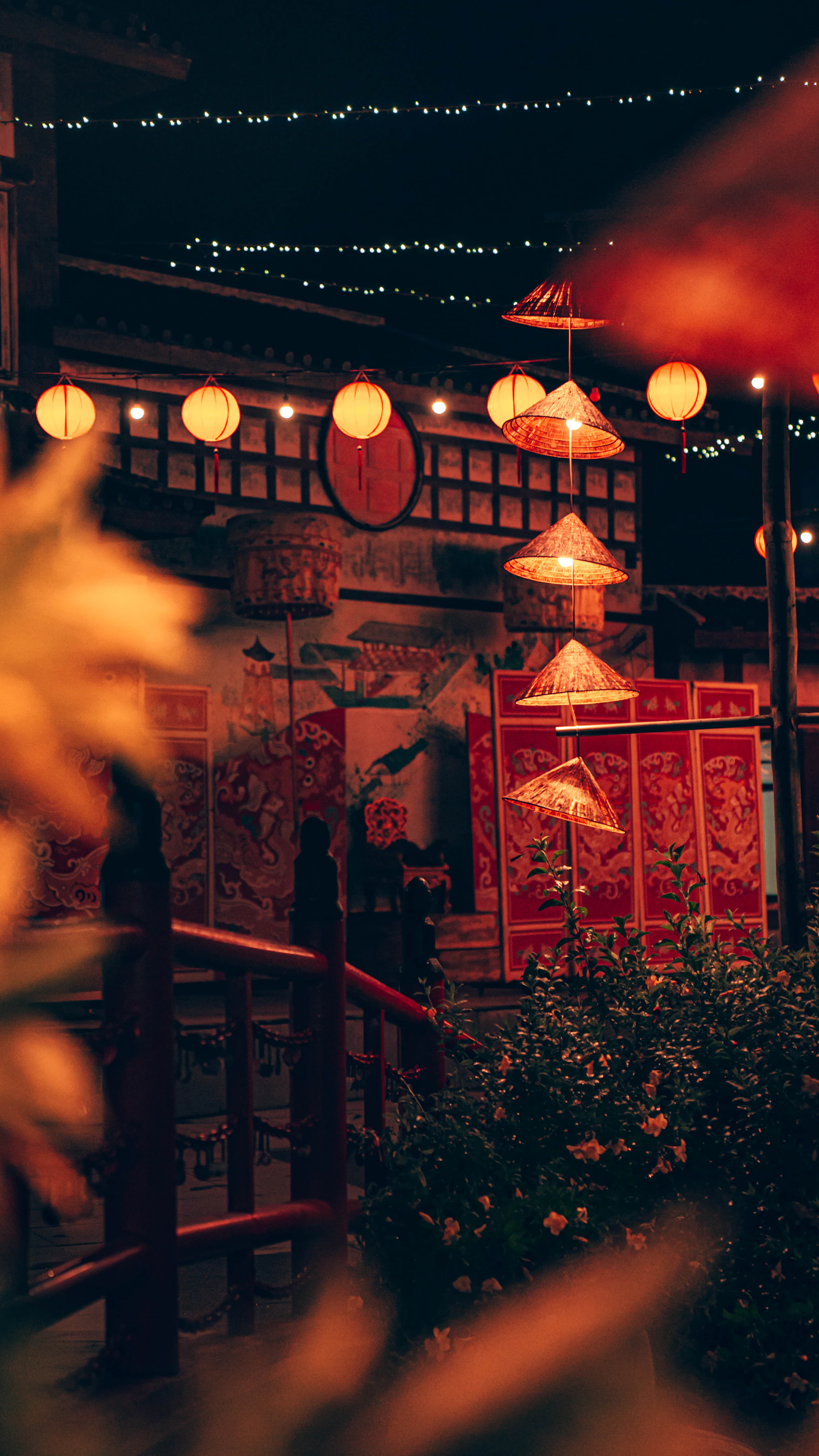 A warmly lit heritage building decorated with lanterns in Hoi An