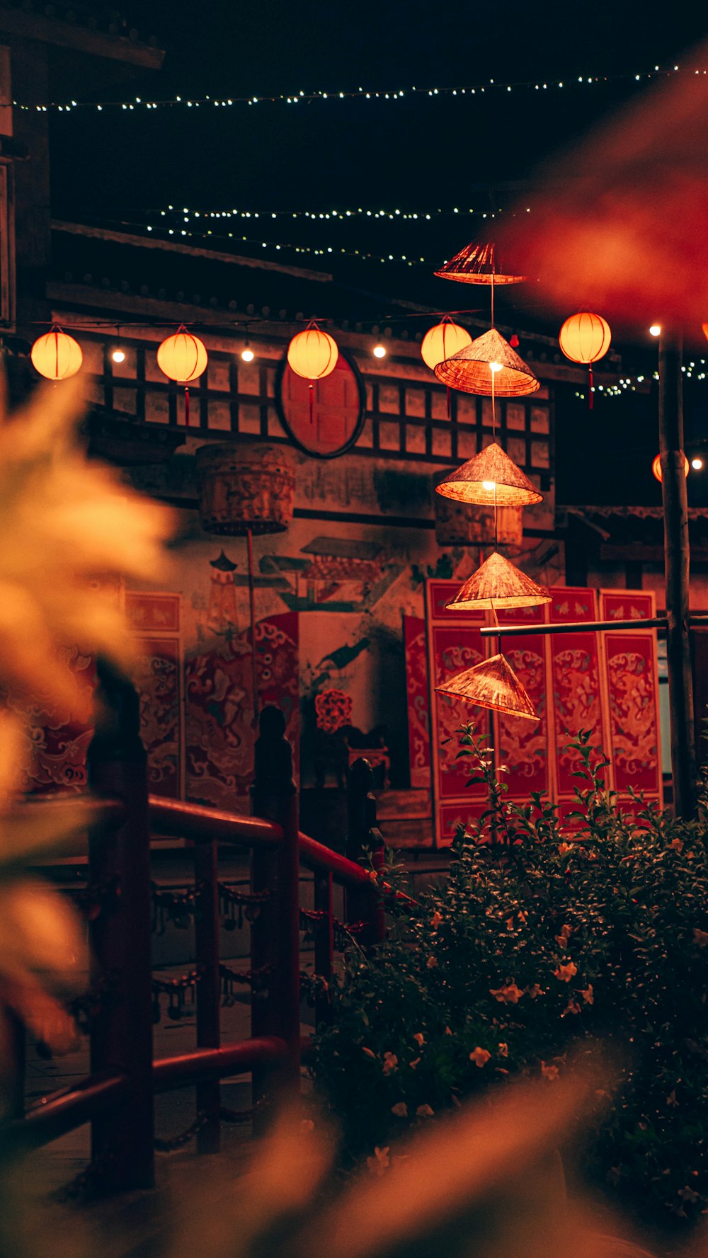 a building with lanterns hanging from it's roof