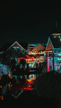 A night scene in Puerto Escondido with glowing lanterns and local musicians playing.