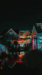 A warm, inviting evening scene of a lively Lonavala street with people enjoying music and art under soft golden lights.