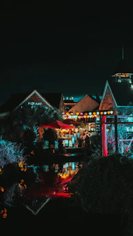 A night scene in Puerto Escondido with glowing lanterns and local musicians playing.