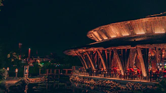 A warm, inviting dining area with traditional Indian decor and a view of the Ganges at sunset