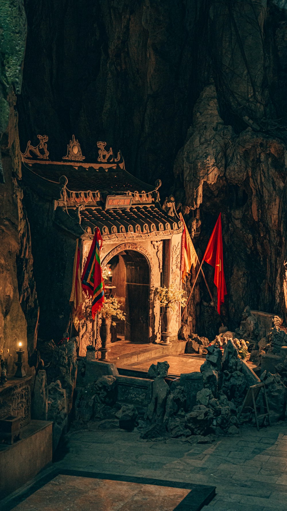 a cave with flags and a fire place