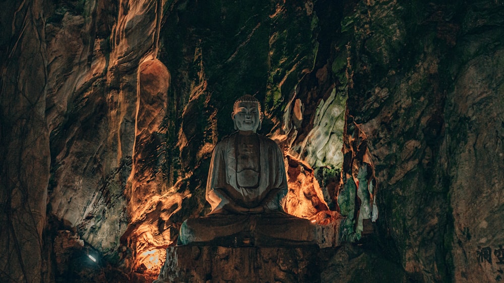 a statue of a buddha in a cave