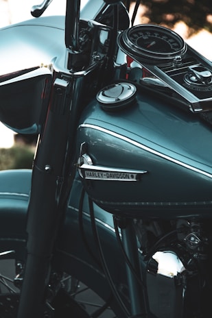 Before and after side-by-side images of a rocker panel repair on a classic Harley, highlighting the flawless finish.