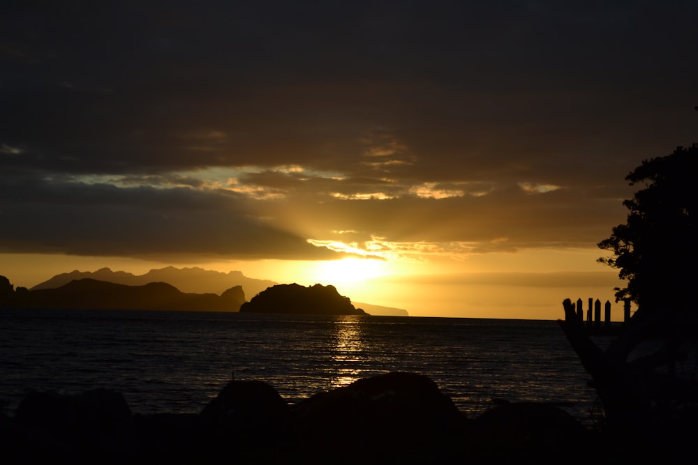 the sun is setting over a body of water