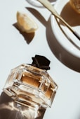 A sleek elroxy perfume bottle resting on a sunlit windowsill with soft shadows.