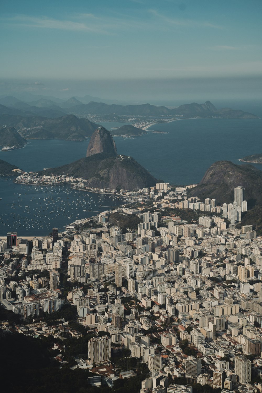 an aerial view of a city with mountains in the background