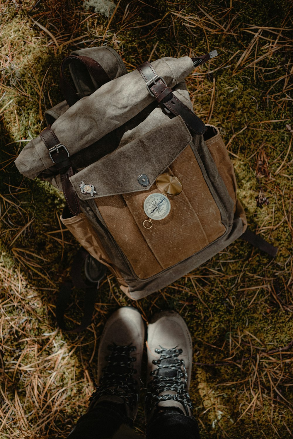 a person standing in the grass with a backpack