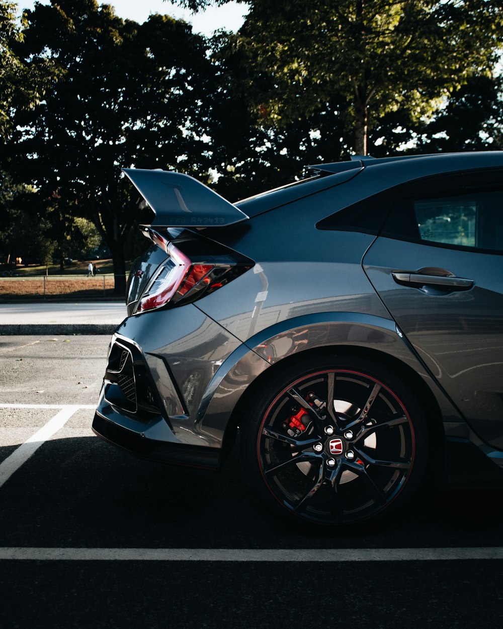 a car parked in a parking lot with its trunk open