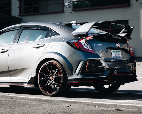 A shiny 2019 Honda Civic parked in front of a classic Americana diner with neon signs.