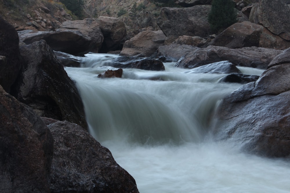 a stream of water running between large rocks