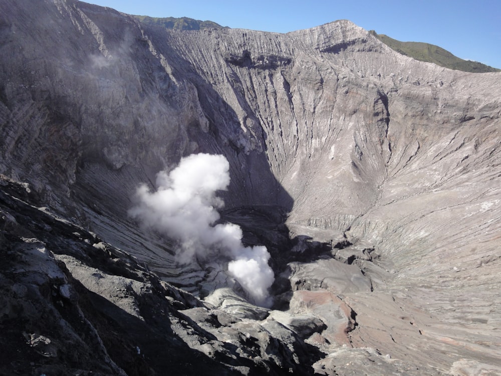 a view of a mountain with steam coming out of it