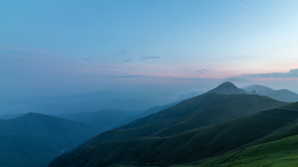 a scenic view of a mountain range at dusk