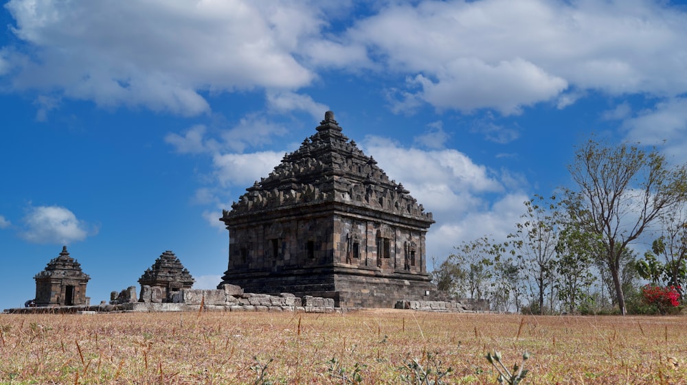 a large stone structure in the middle of a field