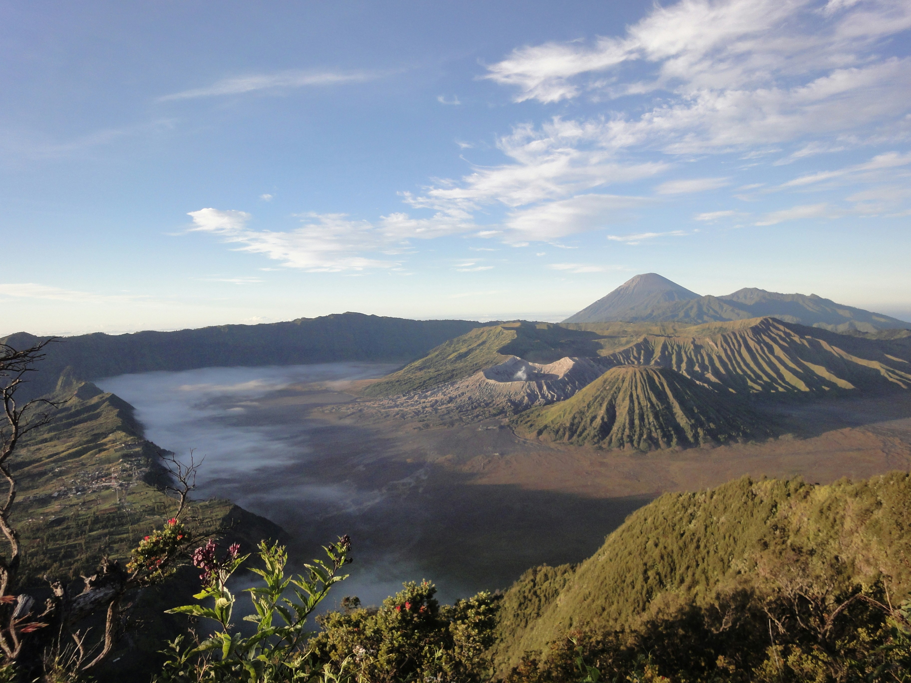 a view of a mountain range with a lake in the foreground