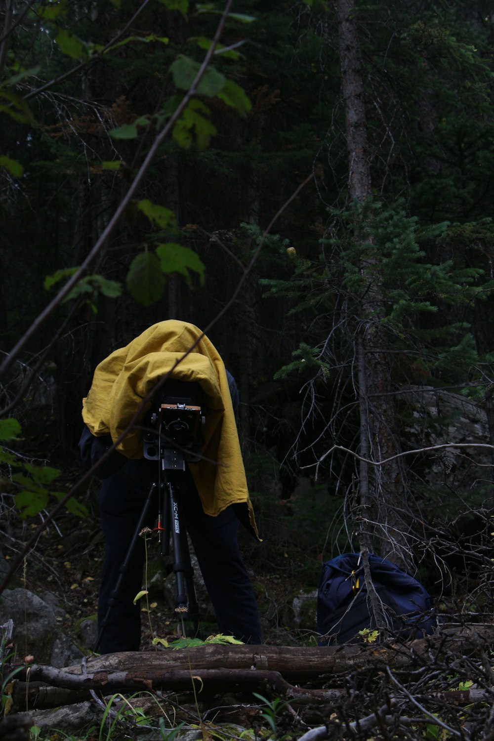 a man in a yellow jacket standing next to a bike