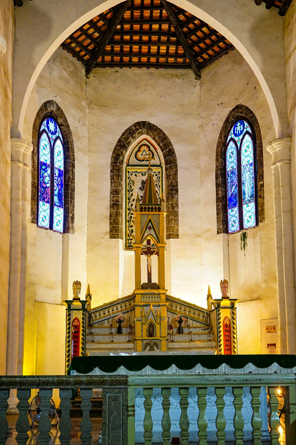 a church with stained glass windows and a balcony