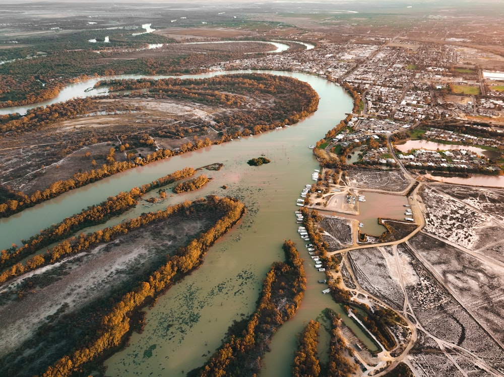 an aerial view of a river running through a city