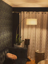 A cozy living room corner featuring smart lighting and a modern speaker.