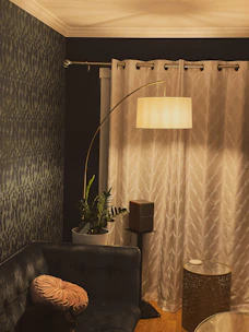 A cozy living room corner featuring smart lighting and a modern speaker.