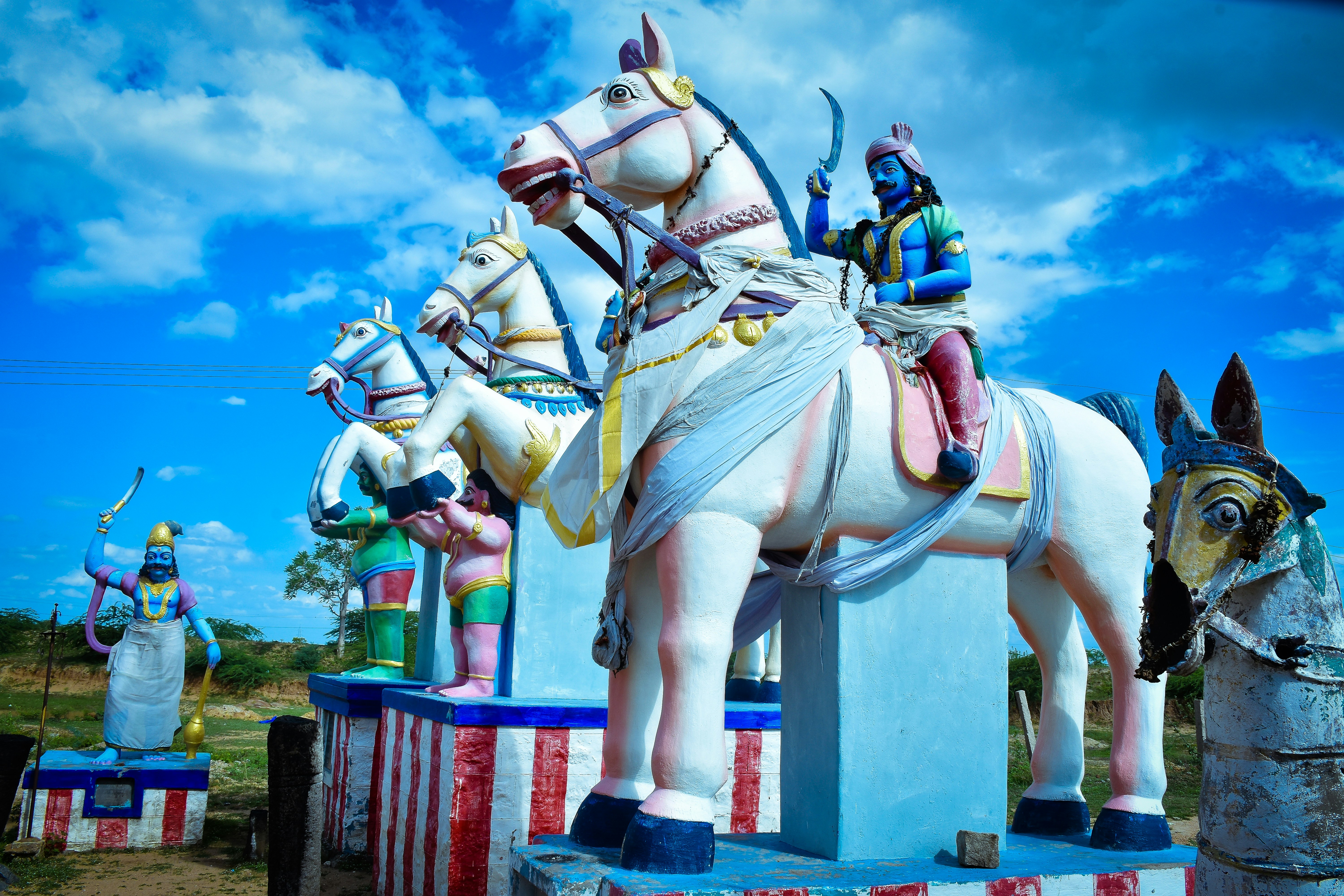 a statue of a man riding a horse next to other statues