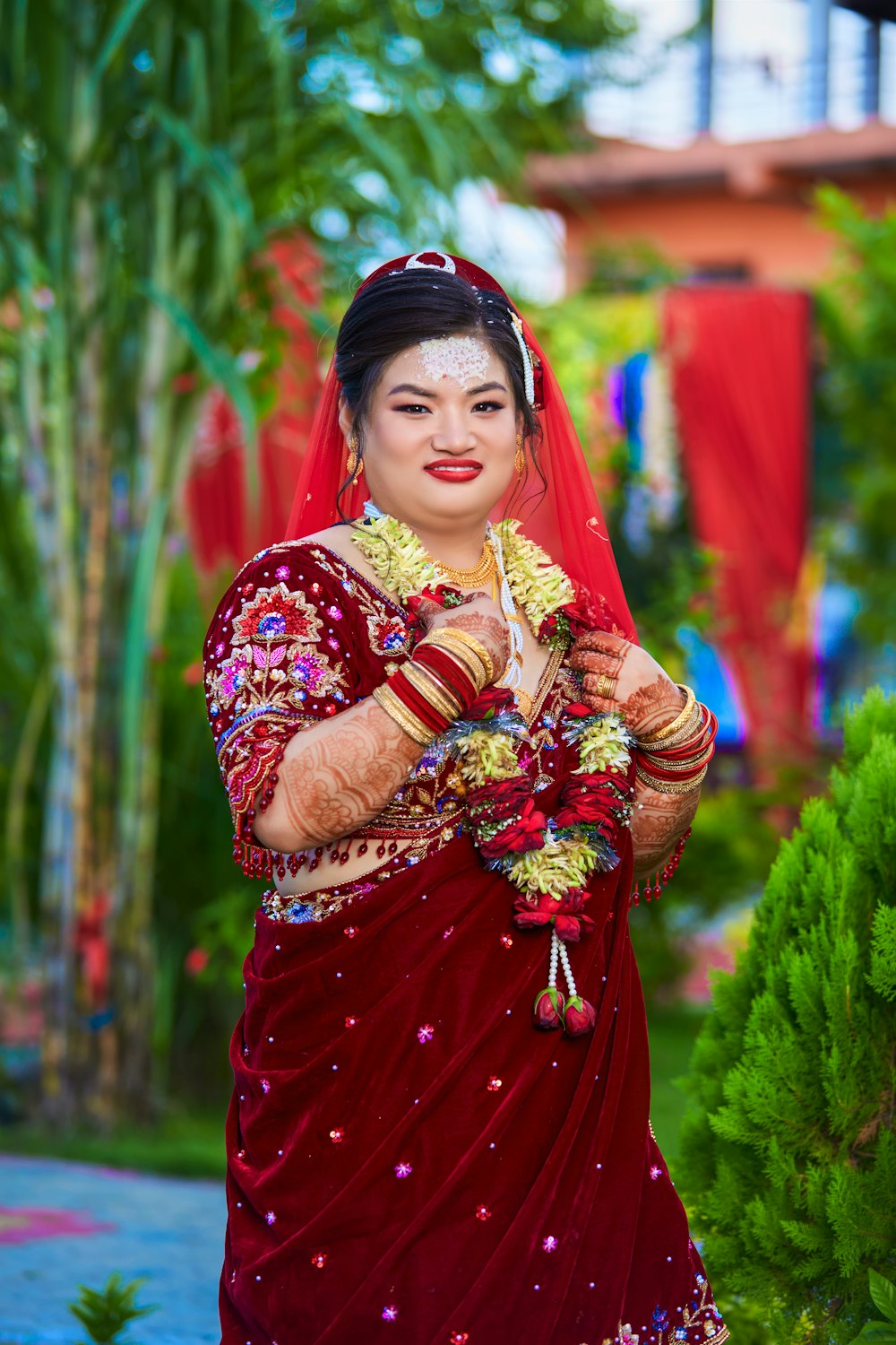 a woman in a red dress holding a bouquet of flowers