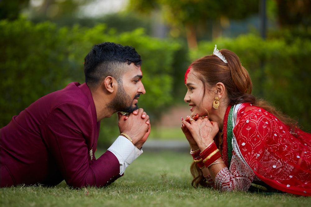 a man and a woman laying on the grass