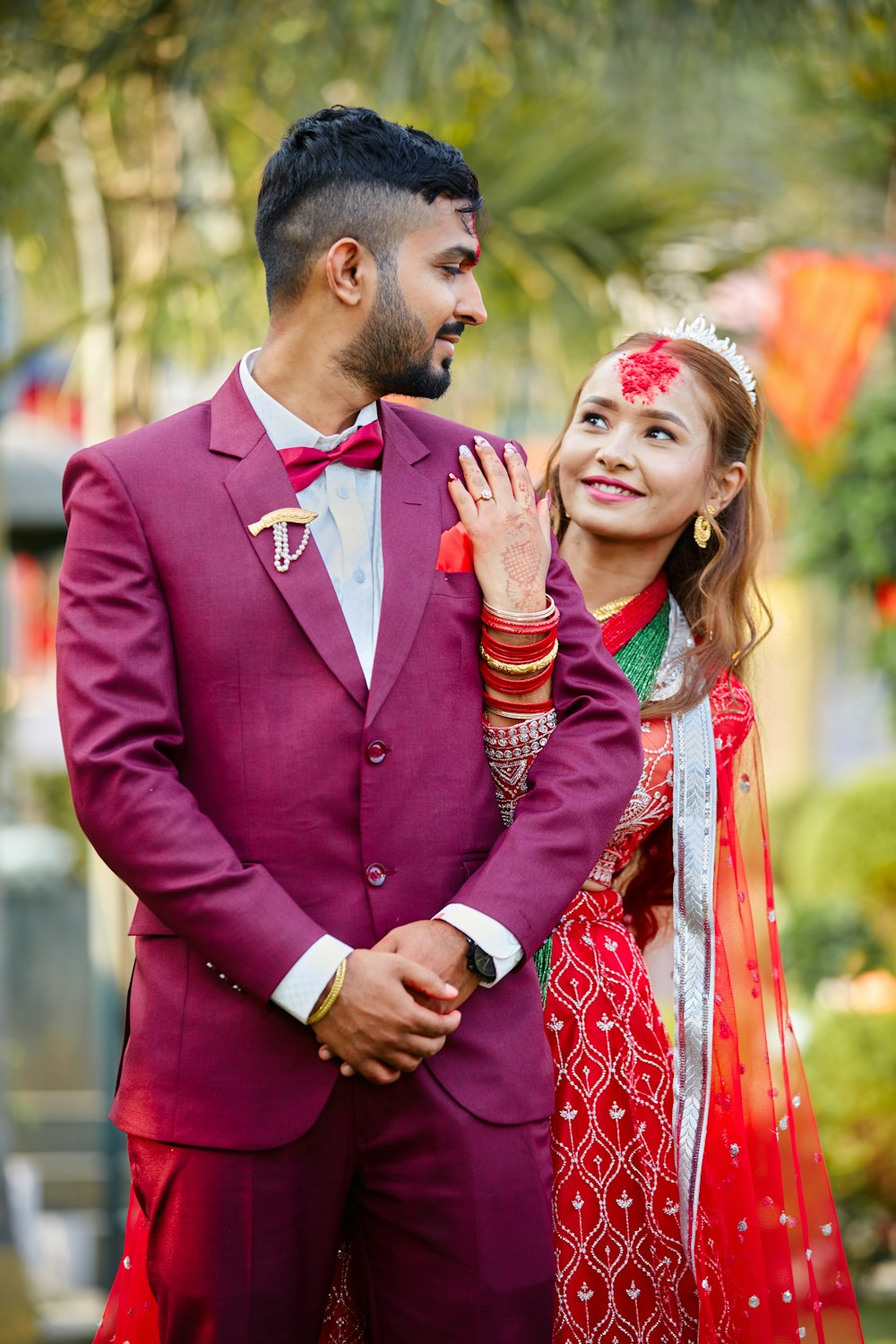 a man and a woman dressed in red standing next to each other