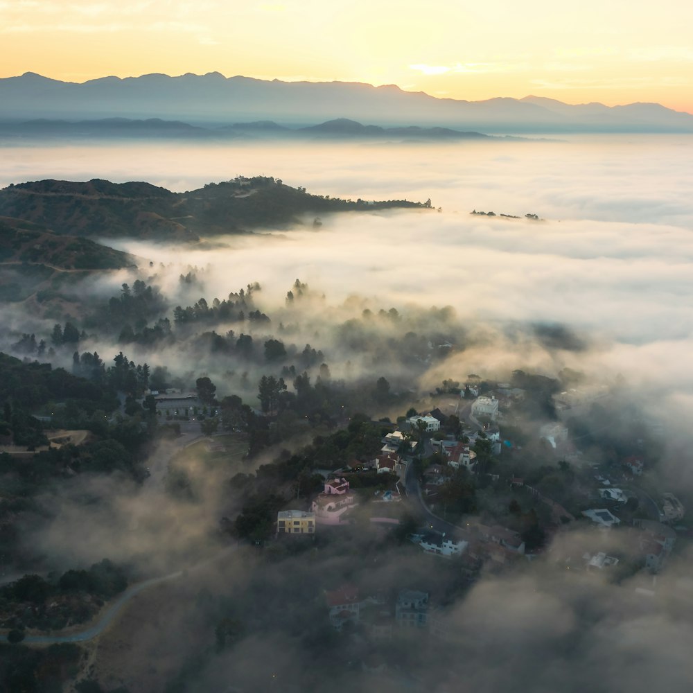 an aerial view of a town surrounded by fog
