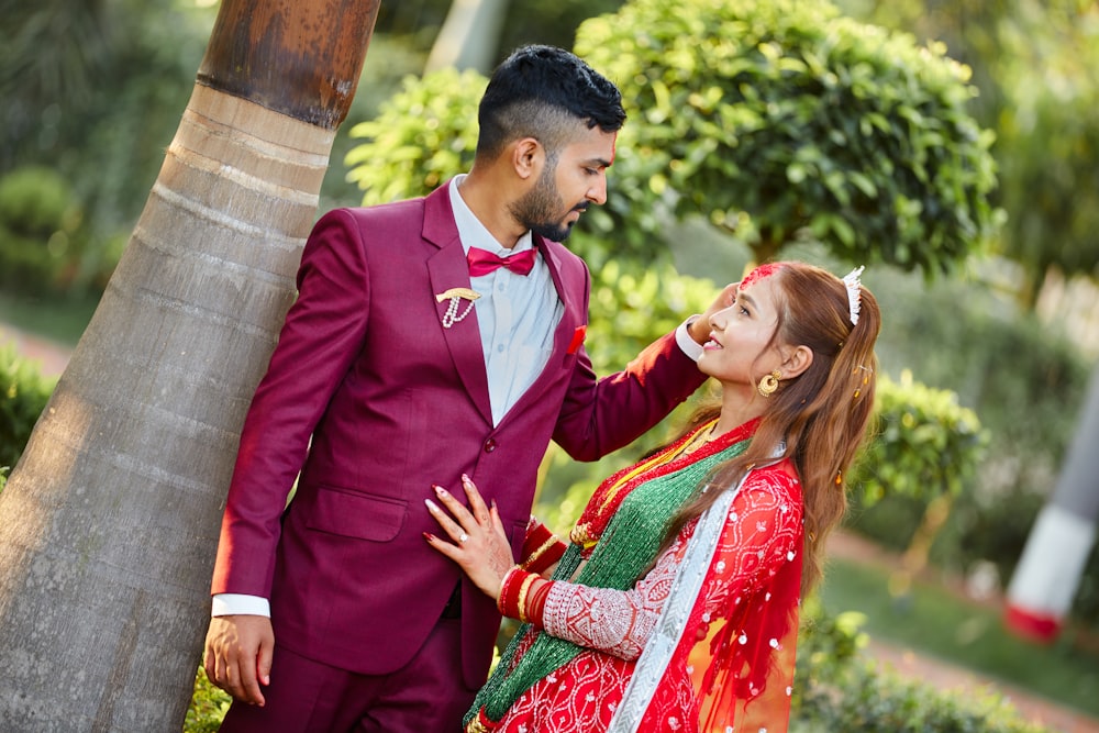 a man in a red suit and a woman in a green dress