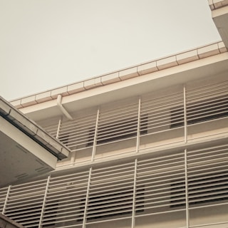 Exterior view of a property showcasing modern architecture with black and gray tones and golden trim