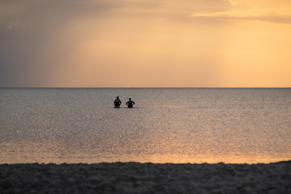 a couple of people riding on the back of a motorcycle