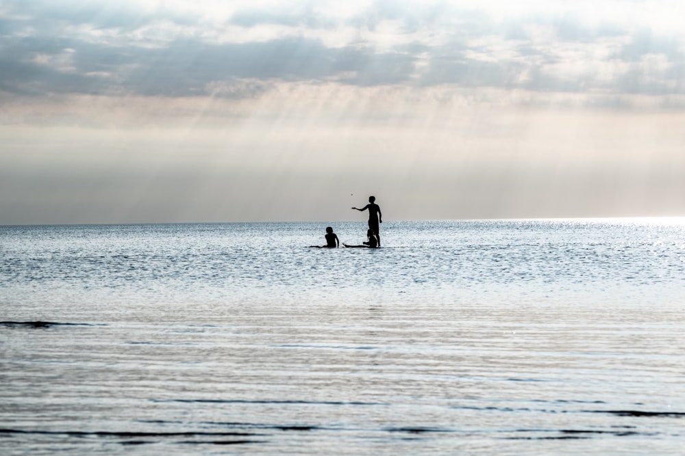 a person standing on a surfboard in the ocean