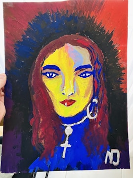 A vibrant portrait painting of a woman with bright yellow skin, blue eyes and lips, and red hair. The background has a gradient of dark brown, blue, and red. The woman is adorned with a large hoop earring in one ear and a necklace featuring a cross and a round pendant. The painting includes bold brush strokes and vivid colors.