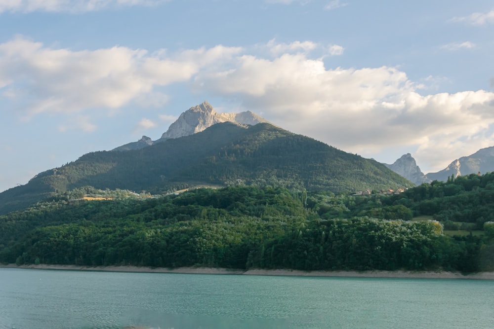 a large body of water with a mountain in the background