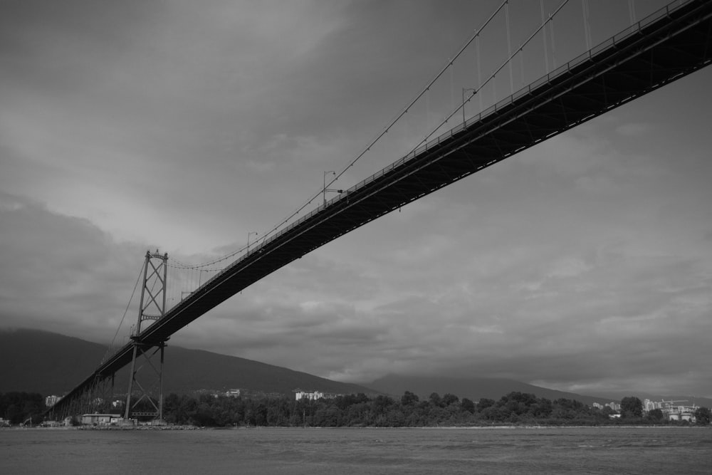 a black and white photo of a suspension bridge